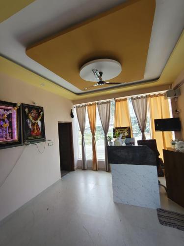 a living room with a ceiling with a fan at Shri Durga Paradise in Tumkūr