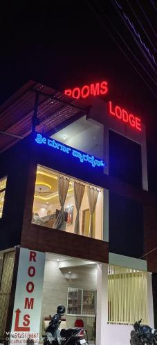 a store with motorcycles parked outside of it at night at Shri Durga Paradise in Tumkūr