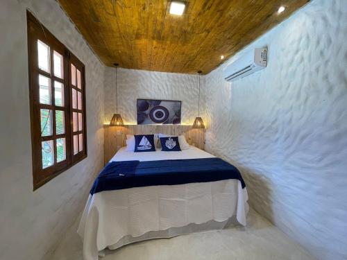 a bedroom with a bed with a speaker on the wall at Villa da Praia -Orla de Atalaia in Aracaju