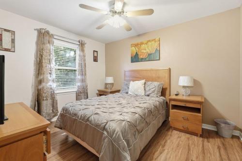 a bedroom with a bed and a ceiling fan at Next Stop! Comfort! 3 BR Near Amtrak Station! in Richmond