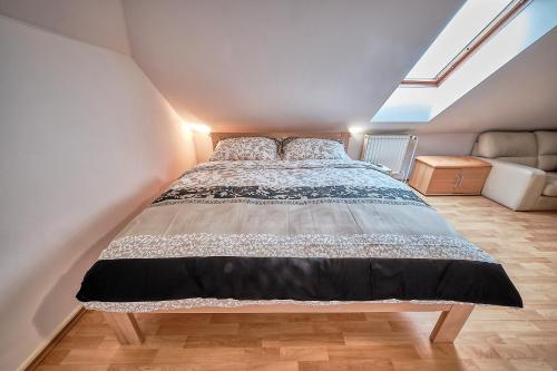 a bedroom with a large bed in a attic at Rezidence Jih in Hlavňovice