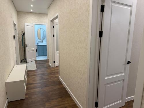 a hallway with a door leading to a bathroom at Baysanat in Karagandy