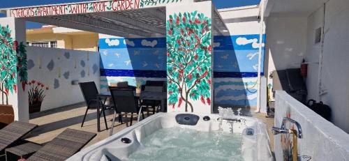 a jacuzzi tub in the middle of a patio at Stergios top view residence with jacuzzi in Kolymbia