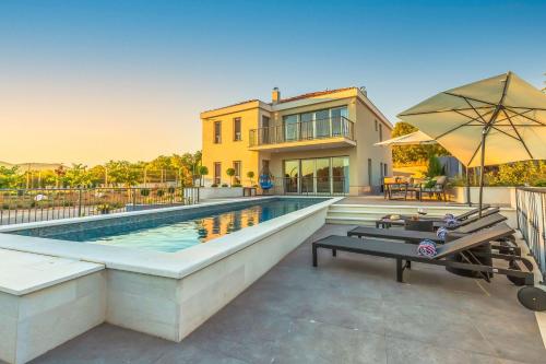 a home with a swimming pool and a house at Ferienhaus In Dugopolje Mit Privatem Pool in Dugopolje