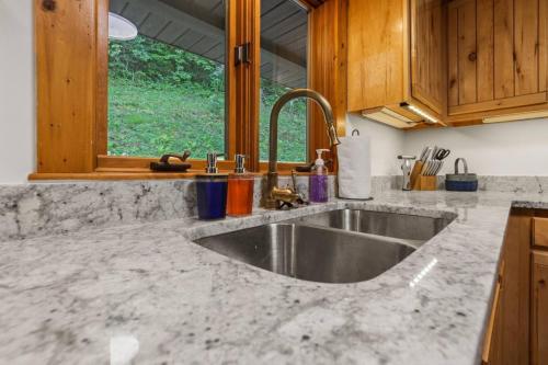 a kitchen counter with a sink and a window at Lakefront in Logan (In the heart of Hocking Hills) in Logan