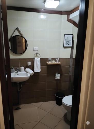 a bathroom with a sink and a toilet at The Runway Inn - Mactan Cebu in Mactan