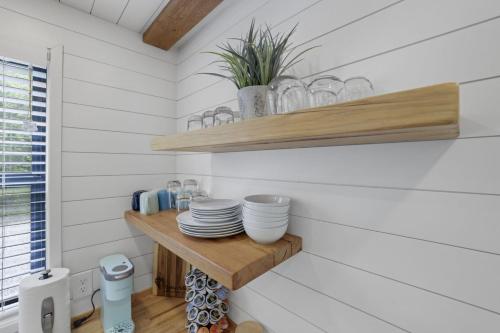 a small kitchen with white walls and wooden shelves at Hiltop Haven The Top Deck in Rockbridge