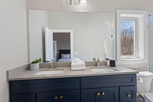 a bathroom with two sinks and a large mirror at Mountain View C - Mountain Stay, King Suite, Fireplace, and Mountain Views in Cullowhee