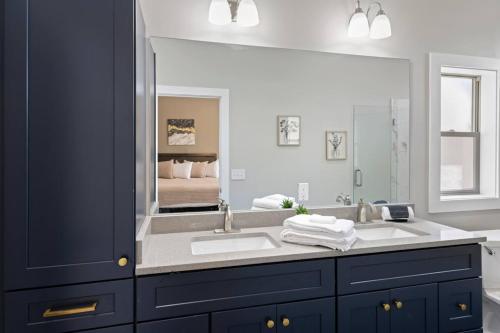 a bathroom with a sink and a large mirror at Valley View C - Mountain Retreat, Cozy Balcony, and Grill in Cullowhee