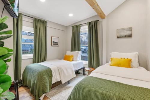 two beds in a room with green curtains at Gone Fishin in Buckeye Lake