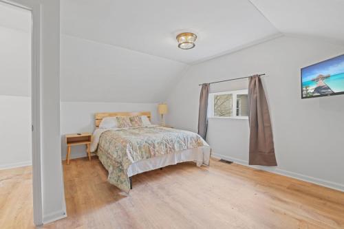 a bedroom with a bed and a window at The Landing Spot in Summit Station