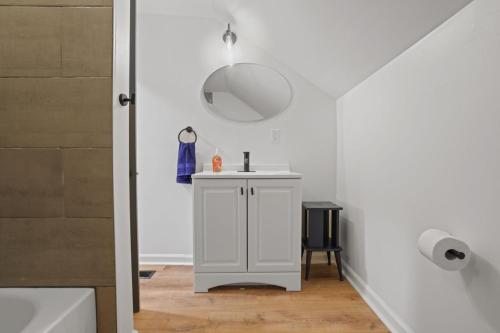 a white bathroom with a sink and a shower at The Landing Spot in Summit Station