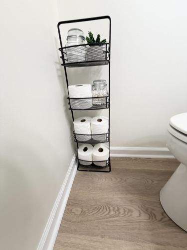 a bathroom with a black shelf with rolls of toilet paper at Normandy Breeze in Wilmington