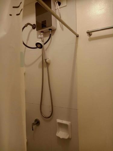 a shower in a bathroom with a toilet at Condotels RQ Hob in Manila