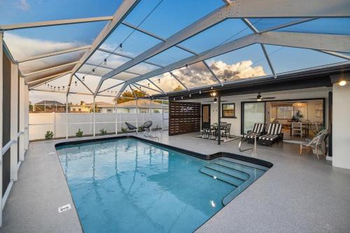 a swimming pool in a house with a roof at Stylish coastal retreat with Heated Saltwater pool in Port Charlotte