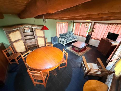 an overhead view of a living room with a table and chairs at Tres Coronas in San Martín de los Andes
