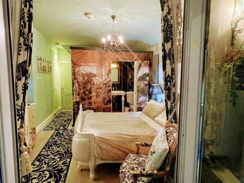 a bedroom with a bed and a mirror at Spend a night in Paris whilst visiting Swansea in Swansea