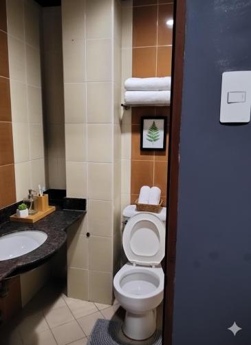a bathroom with a toilet and a sink at Mactan District Budgetel - Lapu Lapu Cebu in Mactan