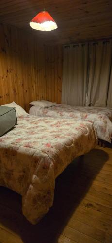 a bed in a room with a red light at Casa Guanaqueros in Coquimbo