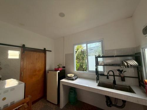 a kitchen with a sink and a window at Sandy house Pai 2 in Pai