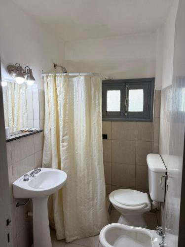 a white bathroom with a sink and a toilet at Italia in La Falda