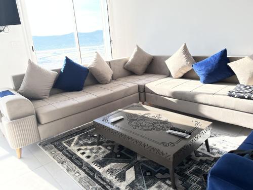 a living room with a couch and a coffee table at Dar Mon Loisir Relaxing Sea View Loft in Tabarka in Tabarka