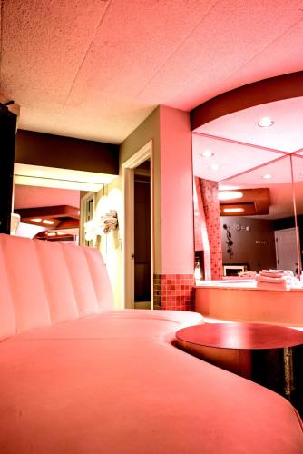 a room with chairs and a table in a restaurant at Essence Suites in Orland Park