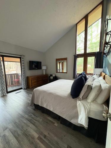 a bedroom with a large bed with pillows on it at Mountain Villas Condo Retreat for 12 in Boyne Falls