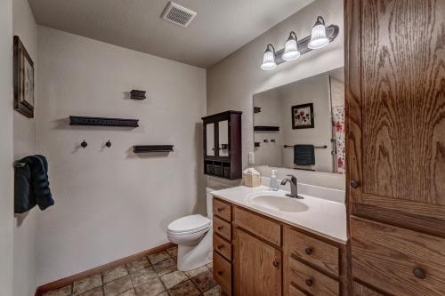 a bathroom with a sink and a toilet and a mirror at Just Like Home, Centrally Located Family Friendly! in Rapid City