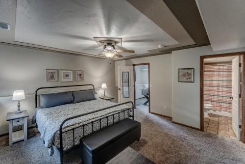 a bedroom with a bed and a ceiling fan at Just Like Home, Centrally Located Family Friendly! in Rapid City