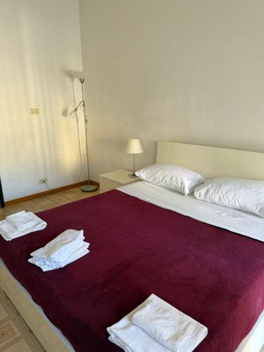 a bedroom with a large bed with towels on it at RUS Apartment in Florence