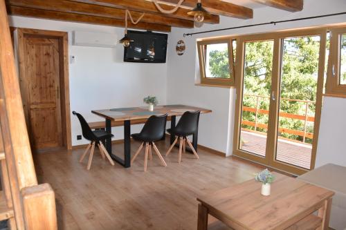 a dining room with a table and chairs at Chata Šumavěnka in Bezděkov