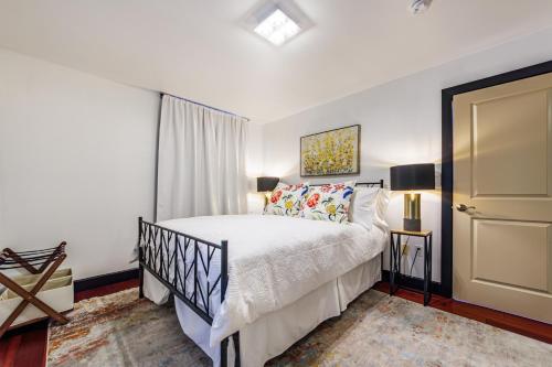 a bedroom with a white bed and a door at Long Beach Apartment - 10 Min Walk to the Beach! in Long Beach