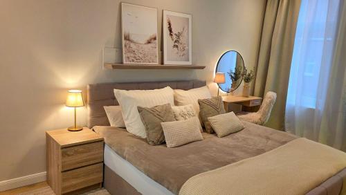 a bedroom with a large bed with pillows at Amadeus Loft in Wilhelmshaven