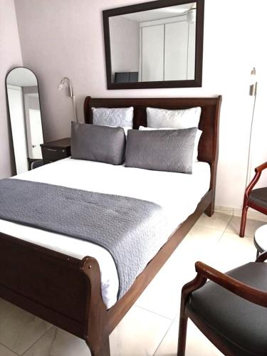 a bedroom with a large bed with a mirror on the wall at Durban Oceanic 82B in Durban