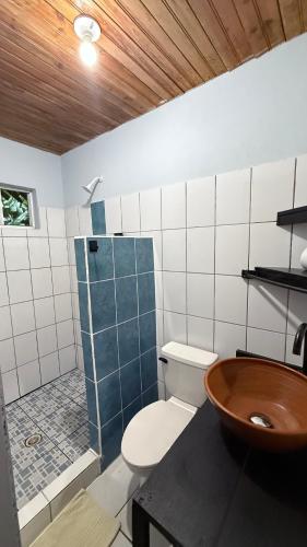 a bathroom with a toilet and a sink and a shower at Las Palmeras OceanView Hotel and Dive Center in Little Corn Island