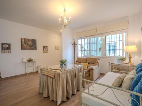a living room with a couch and a table at Apartment in Peñaflor with Charming Patio in Peñaflor