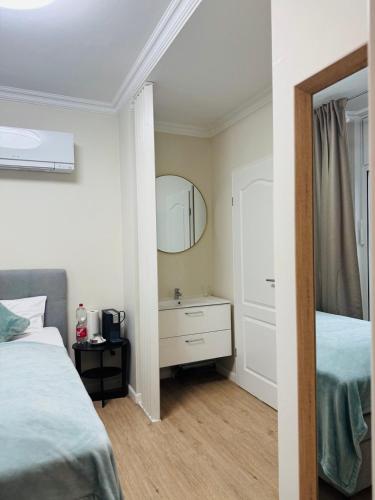 a bedroom with a bed and a dresser with a mirror at eco Appartements Reichel in Baden-Baden