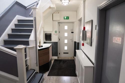 a hallway with stairs and a stair case at Hills View Apartments in Manchester