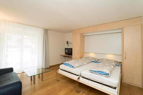 a bedroom with a bed and a couch at Chesa Quadrella in Pontresina