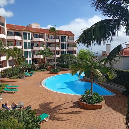 a swimming pool in front of a apartment building at Varandas do Funchal Apartment in Funchal