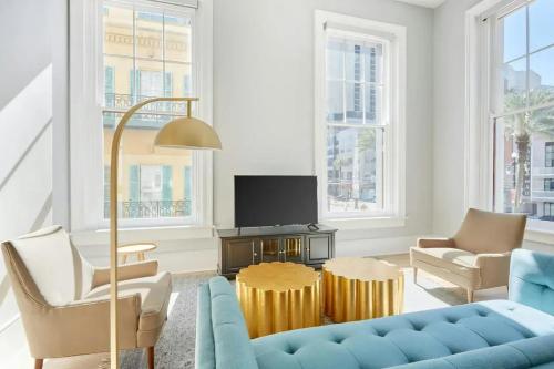 a living room with a blue couch and chairs at The Harlequin by AvantStay in New Orleans