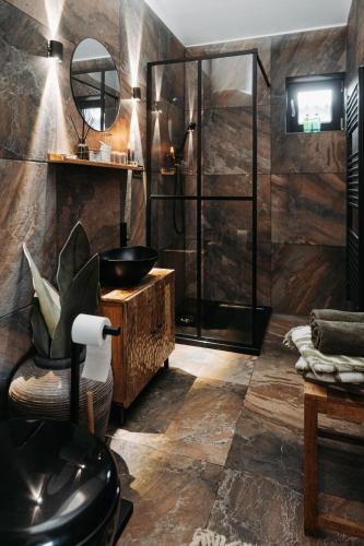 a bathroom with a sink and a glass shower at Záhradný domček pri Slovenskom raji in Smižany
