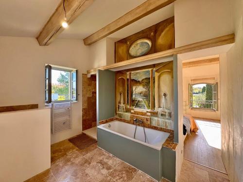 a bathroom with a bath tub in a room at Mas d Anissa in Avignon