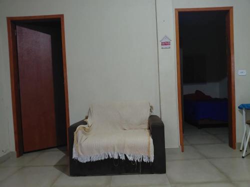 a chair with a blanket on it in a room at Estância arco iris in Regente Feijó