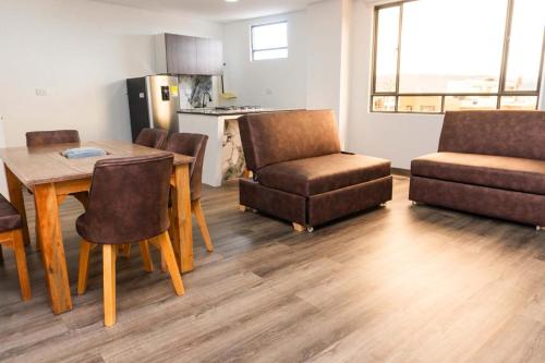 a kitchen and living room with a table and chairs at Hotel Salinero - Zipaquirá in Zipaquirá