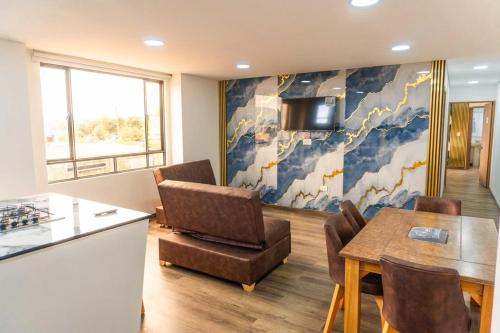 a kitchen and dining room with a table and chairs at Hotel Salinero - Zipaquirá in Zipaquirá