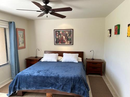 a bedroom with a bed with a ceiling fan at Rancho Mirage Gem! 90 day-bookings only in Rancho Mirage