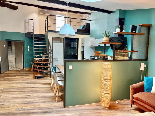a living room with green walls and a staircase at Myzenplace - Duplex 100m2 - Fibre - Cosy et atypique - Centre piéton in Montélimar