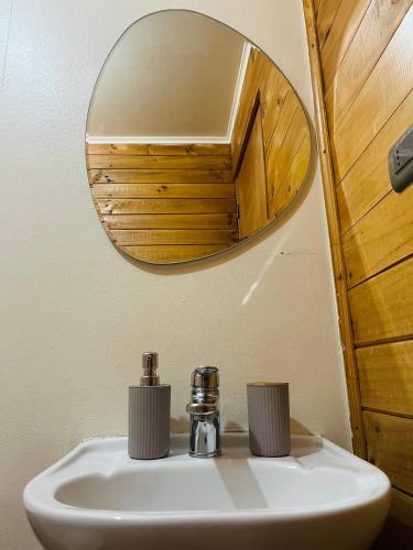 a bathroom with a sink and a mirror at Cabañas Piedra Viva 2 in San Pedro de Atacama